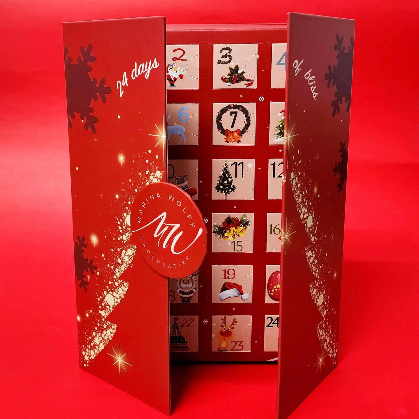 A red rectangular box that is opened and written ' 24 days of bliss' on it with Christmas figures in each little square with sequential numbers on a red background.